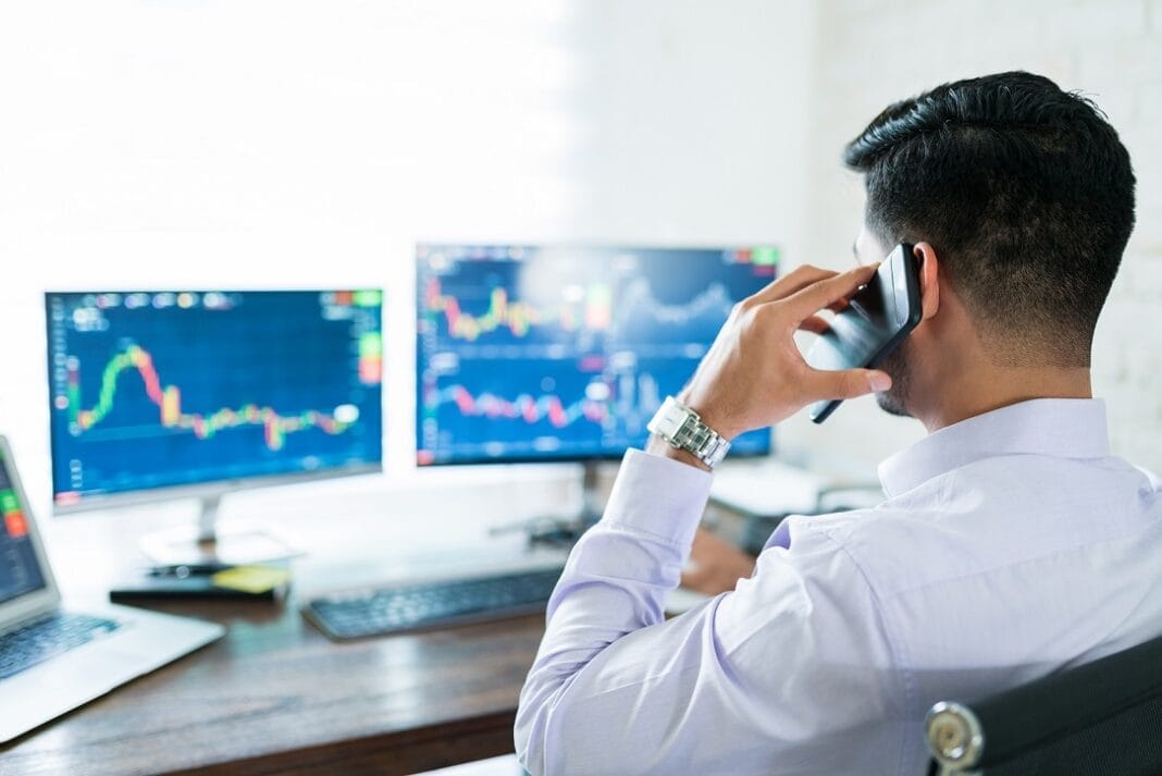 Young Male Stock Broker Using Computer For Buying Shares Routine Trader Forexdaily.net
